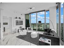 Modern living room featuring floor-to-ceiling windows and contemporary furnishings showcasing city views at 777 N Ashley Dr # 2613, Tampa, FL 33602