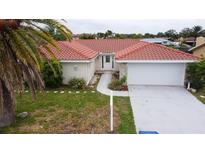 Single-Gathering home with tile roof and two-car garage at 9830 San Sierra Way, Port Richey, FL 34668