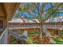 Exterior view of condo building with stairs and courtyard at 10036 63Rd N Ave # 23, St Petersburg, FL 33708
