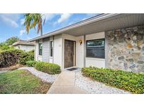 House exterior with a stone facade and a landscaped walkway at 1601 43Rd N St # 114, St Petersburg, FL 33713