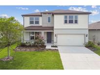 Charming two-story home with well-maintained landscaping and an attached two-car garage at 4187 Feldspar Ln, Spring Hill, FL 34609