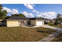 Single-story house with attached garage and well-maintained lawn at 5344 Lowell Ave, Spring Hill, FL 34609