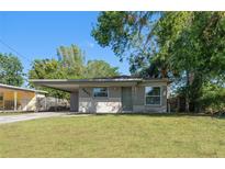 Charming ranch-style home with a well-maintained lawn at 3305 W Kathleen St, Tampa, FL 33607