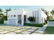 Modern house with white walls, gray accents, and a two car garage at 19234 Causeway Blvd, Land O Lakes, FL 34638