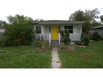 Charming bungalow with yellow door and white railing at 2234 36Th N Ave, St Petersburg, FL 33713