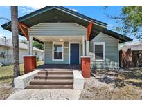 Charming single-story home with a covered front porch and brick-accented columns at 1312 E Louise Ave, Tampa, FL 33603