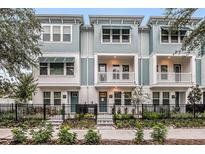 Three-story townhouses with light blue siding, balconies, and black metal fencing at 2115 1St N Ave, St Petersburg, FL 33701