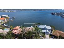 Aerial view of waterfront property with large lot and neighboring houses at 6351 4Th Palm Pt, St Pete Beach, FL 33706