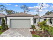 Charming single-story home showcasing a two-car garage and beautifully landscaped front yard at 9434 Shorebird Ct, Parrish, FL 34219