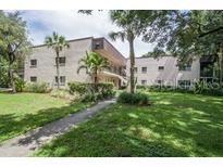 Two story building with lush green landscaping at 11701 Raintree Village Blvd # C, Temple Terrace, FL 33617