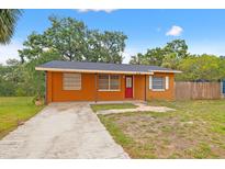 Charming single-story brick home with a red front door and well-maintained lawn in a quiet neighborhood at 225 35Th N St, St Petersburg, FL 33713