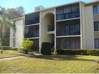 Two-story building exterior with balconies and landscaping at 3161 Lake Pine S Way # B1, Tarpon Springs, FL 34688
