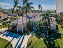 Beautiful home exterior with palm trees and landscaping at 5944 Bay S Dr, Gulfport, FL 33707