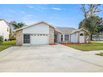 Front view of a single-Gathering home with a two-car garage at 8404 Millwood Dr, Hudson, FL 34667