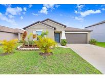 Charming single-story home with a well-manicured lawn and a two-car garage, perfect for suburban living at 9407 Channing Hill Dr, Ruskin, FL 33573