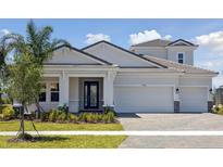 Beautiful one-story home with a three car garage, manicured lawn and covered porch entrance at 17525 Glistening Ct, Venice, FL 34293