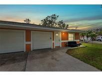 Exterior view of duplex with two-car garage and front porch at 3332 W Heiter St, Tampa, FL 33607