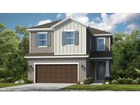 Two story home with brown garage door and gray siding at 759 Steel Dr, Apollo Beach, FL 33572