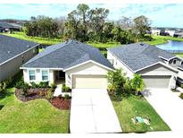 Aerial view of two-story house with landscaped yard at 8519 Sunshower Pl, Parrish, FL 34219