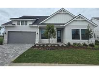 Charming single-Gathering home showcasing modern architectural design and a well-manicured front yard at 18136 Foxtail Loop, Venice, FL 34293