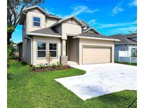 Two-story house with beige siding, gray roof and a two-car garage at 3033 54Th N Ave, St Petersburg, FL 33714