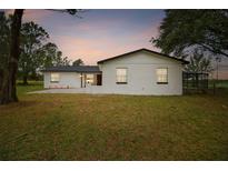 Newly renovated ranch house with white exterior and spacious yard at 4401 Platt Rd, Plant City, FL 33565