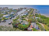 Aerial view of a waterfront home with a private pool and lush landscaping at 5104 W San Jose St, Tampa, FL 33629