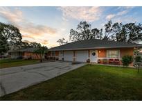 Orange duplex with a 2 car garage and landscaped yard at 3336 W Heiter St, Tampa, FL 33607