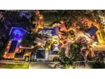 Stunning aerial view of the estate grounds and pool, illuminated beautifully at night at 518 Riverside Dr, Tarpon Springs, FL 34689