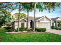 Single story home with a two-car garage and manicured lawn at 905 Oxford Park Dr # A, Sun City Center, FL 33573