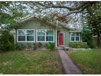 Green house with red door and walkway at 3227 16Th N St, St Petersburg, FL 33704