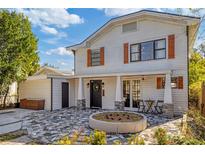 Two-story home with inviting front porch and landscaping at 206 W Frierson Ave, Tampa, FL 33603