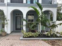 Townhouse exterior with landscaped front yard and arched entryway at 630 3Rd S Ave, St Petersburg, FL 33701