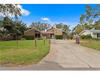 House exterior showcasing a split-level home with stone and wood siding at 715 S Himes Ave, Tampa, FL 33609