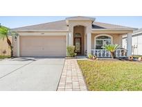 One-story home with a two-car garage and landscaped front yard at 11449 Weston Course Loop, Riverview, FL 33579