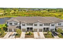 Three-unit townhouse building with attached garages and landscaping at 3632 Bellmeade Ct, Wesley Chapel, FL 33543
