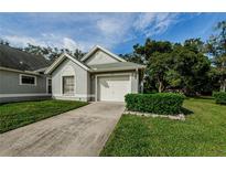 Single story home with a one car garage and well maintained landscaping at 3647 Muirfield Ct, New Port Richey, FL 34655