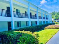 Well-maintained apartment building with lush landscaping and inviting walkways under a sunny sky at 2060 Marilyn St # 239, Clearwater, FL 33765