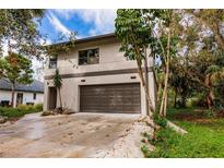 Modern two-story house with a large garage and landscaped yard at 21048 Peachland Blvd, Port Charlotte, FL 33954