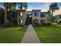 Two-story condo building with lush landscaping at 356 Moorings Cove Dr # 356, Tarpon Springs, FL 34689