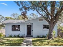 Charming light blue house with a dark brown door and landscaped yard at 4237 Dr Martin Luther King Jr N St, St Petersburg, FL 33703