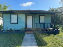 Charming light teal single story home with a porch at 847 Hand Ave, Sarasota, FL 34232
