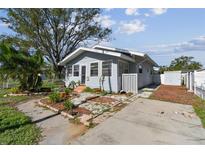 Charming bungalow with a newly painted exterior and a small front yard at 1757 New Hampshire Ne Ave, St Petersburg, FL 33703