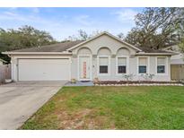 Single story house with attached garage and front yard at 2102 Deltona Blvd, Spring Hill, FL 34606