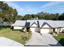 Charming single-story home featuring a well-manicured lawn and inviting curb appeal at 3499 Cedar Ln, Palm Harbor, FL 34684