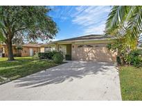 Single-story house with attached garage and landscaped lawn at 4175 103Rd N Ave, Clearwater, FL 33762