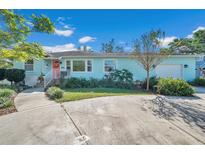 Charming light blue house with well-maintained landscaping at 628 32Nd N Ave, St Petersburg, FL 33704