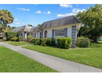 White building with gray roof and landscaping, in a residential neighborhood at 4220 Sheldon Pl # 4220, New Port Richey, FL 34652