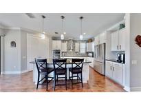 Modern kitchen with white cabinets, granite countertops, and stainless steel appliances at 11101 58Th Street E Cir, Parrish, FL 34219