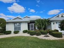 Single-story home with landscaped lawn and attached garage at 2421 E Del Webb Blvd, Sun City Center, FL 33573